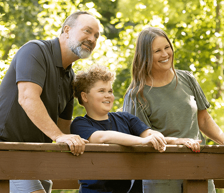 A child with Duchenne muscular dystrophy spending time outdoors with family.